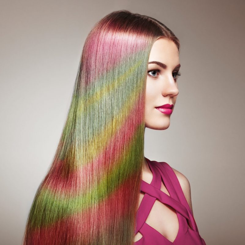 Beauty Fashion Model Girl with Colorful Dyed Hair. Girl with perfect Makeup and Hairstyle. Model with perfect Healthy Dyed Hair. Rainbow Hairstyles